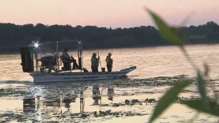 Authorities search Vadnais Lake in the Minneapolis-St. Paul area on Friday for two children and their mother. The body of one child was recovered earlier in the day.