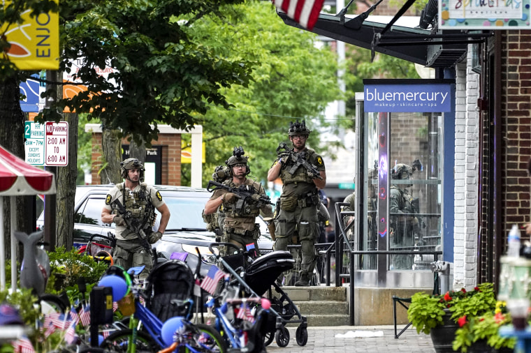 Law enforcement search after a mass shooting at the Highland Park Fourth of July parade in downtown Highland Park, Ill., on July 4, 2022.