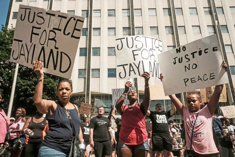 Demonstrators hold "Justice for Jayland" signs outside Akron City Hall