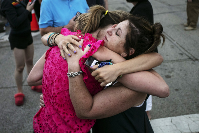 Image: Hillary Heller, Shannon Rowe and Lucy Heller embrace near the scene of a Fourth of July parade mass shooting on July 5, 2022 in Highland Park, Ill.