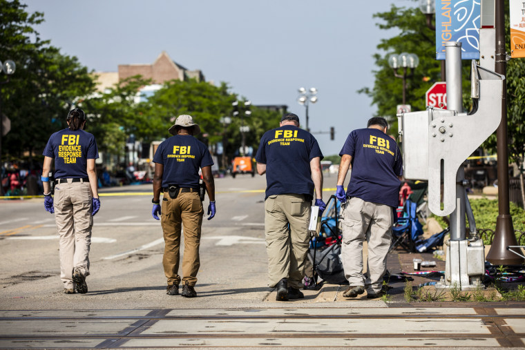 FBI agents work on the place of a shooting during a parade of July 4 on July 5, 2022, in Highland Park, Ill.