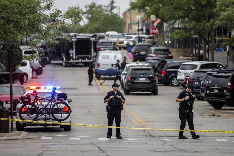 Image: First responders take away victims from the scene of a mass shooting at a Fourth of July parade in Highland Park, Ill., on July 4, 2022.