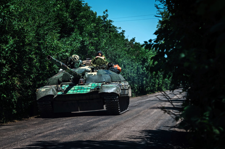 Image: A tank with a Ukrainian soldier heads towards Lysychansk, Ukraine, on June 10, 2022.