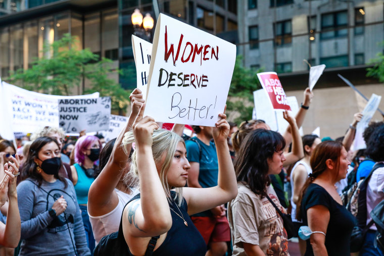 Protesters hold signs during an abortion rights march on June 24, 2022 in Chicago.