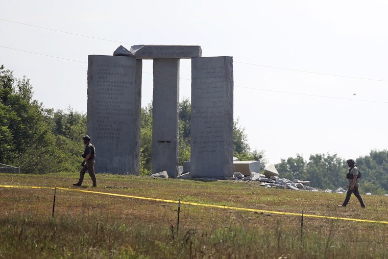 Image: Law enforcement officials walk around the damaged Georgia Guidestones monument near Elberton, Ga., on July 6, 2022.