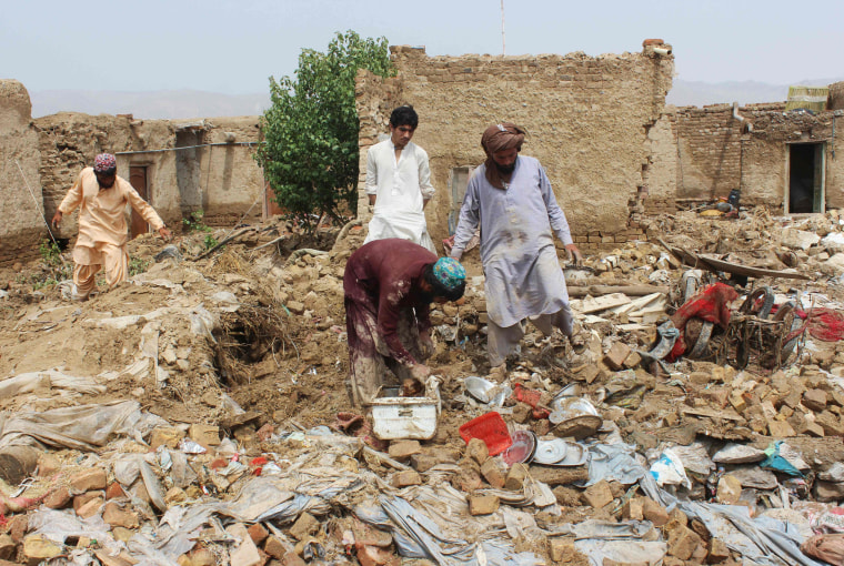 Image: Residents clear debris after the roof of a house collapsed due to a heavy monsoon rainfall on the outskirts of Quetta, Pakistan, on July 5, 2022.