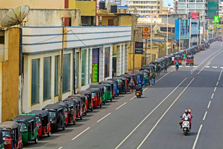 Image: Autorickshaw drivers queue along a street to buy gasoline from a fuel station in Colombo, Sri Lanka, on July 6, 2022.