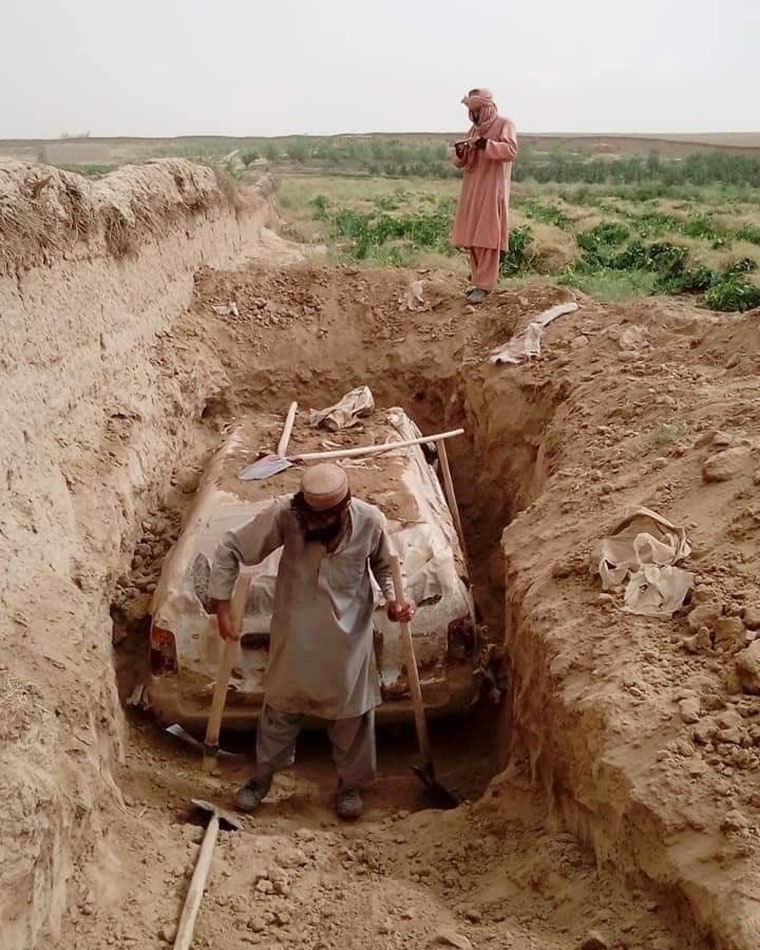 The car was buried beside the mud wall of a traditional village in Afghanistan’s southern Zabul province.