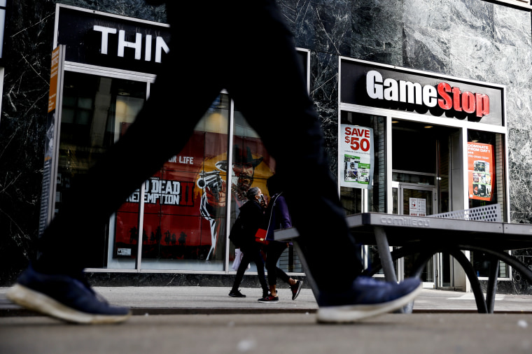 Image: People pass by a GameStop at 6th Avenue on March 23, 2021 in New York.