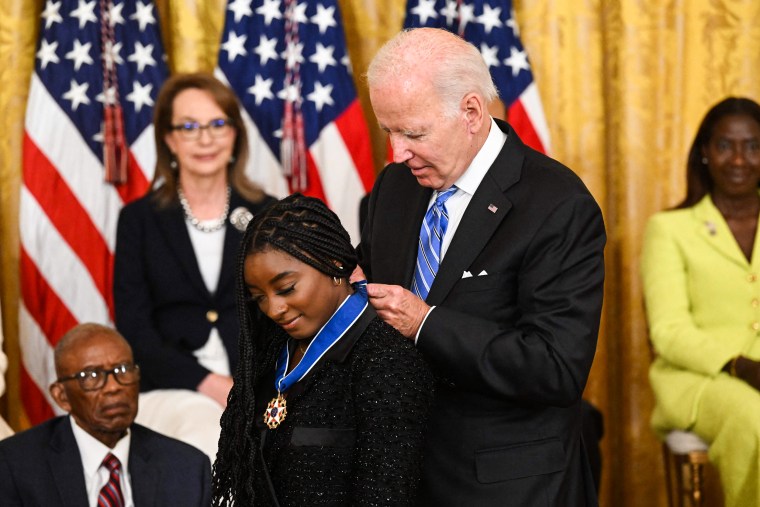 President Joe Biden presents gymnast Simone Biles with the Presidential Medal of Freedom in the East Room of the White House on July 7, 2022.