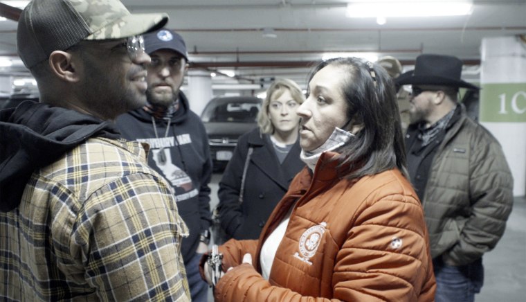 Image: Kellye SoRelle, back center, at a Jan. 5 meeting with Enrique Tarrio of the Proud Boys and Stewart Rhodes of the Oath Keepers.