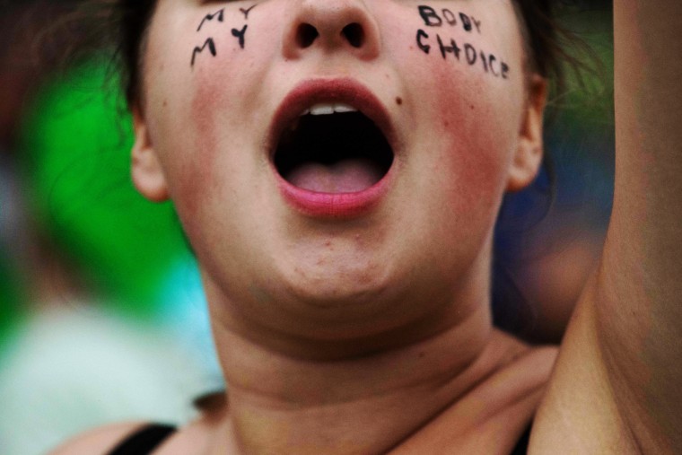 An abortion rights demonstrator shouts during a protest