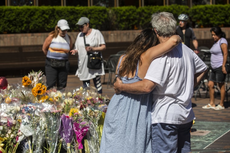 People come to mourn at memorial sites around the city center of Highland Park, Ill., on July 10, 2022.