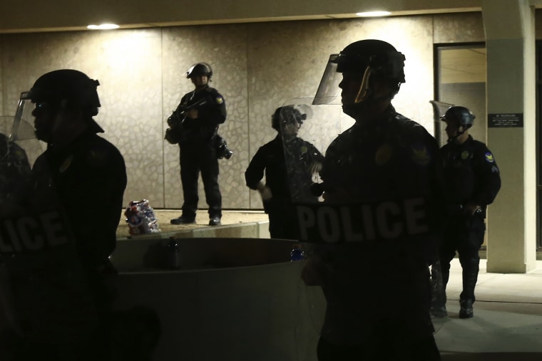 Officers stand in front of the Phoenix police headquarters on May 30, 2020.