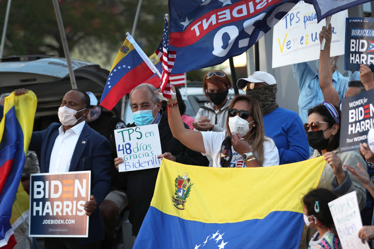 People gather in front of the El Arepazo restaurant to show their support for an order signed by U.S. President Joe Biden that grants temporary protective status for thousands of Venezuelans on March 09, 2021 in Doral, Florida. The Biden administration announced that it will give some 300,000 Venezuelans living in the U.S. the chance to remain and work in the U.S. for 18 months, a move seen by observers as tightening pressure on Venezuelan President Nicolás Maduro.