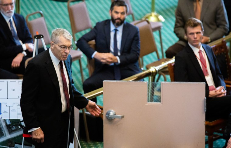 Image: Texas Department of Public Safety Director Steve McCraw demonstrates how an interior door from Robb Elementary School failed to securely lock during a Texas Senate Special Committee hearing in Austin on June 21, 2022.