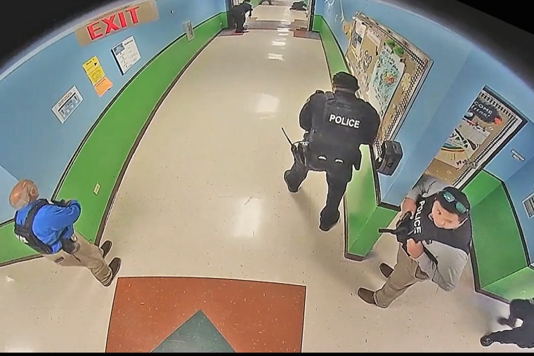 Uvalde police officers enter Robb Elementary School in Texas on May 24.