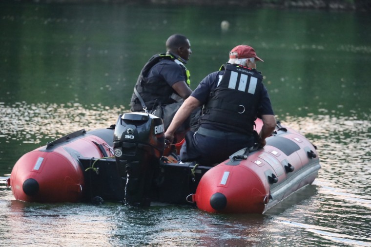 Search and rescue crews worked Tuesday to recover a vehicle from a pond on Bluff Road in Indianapolis. 