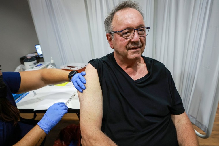 A healthcare worker administers a vaccine to Ed Stupi for the prevention of monkeypox at the Pride Center on July 12, 2022, in Wilton Manors, Fla.