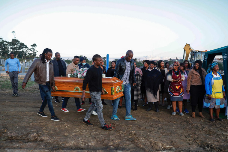Pallbearers carry the coffin of Thembinkosi Silwane at a cemetery in East London on July 6, 2022, after he and 20 people, mostly teens, died in unclear circumstances at a township tavern last month.