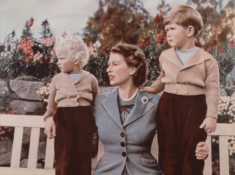 Queen Elizabeth II with Prince Charles, age 4, and Princess Anne in the grounds of Balmoral Castle, Scotland, Sept. 1952. Charles is celebrating his 4th birthday.