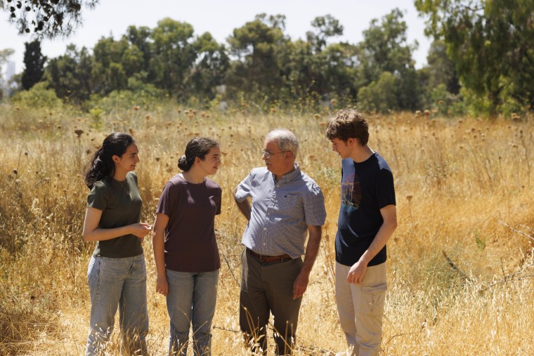 Hasan Khalidi stands on the plot with his children Muna, Lynne and Ragheb. 