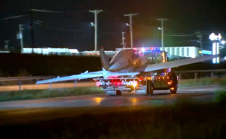 A small plane is towed away after landing on a Missouri highway overnight after running out of fuel. Authorities say the pilot was arrested on suspicion of intoxication.