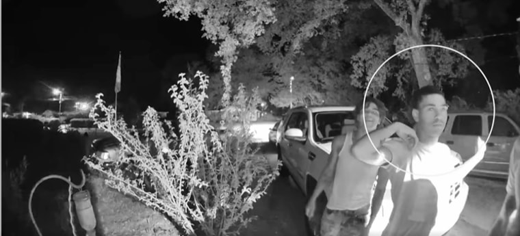 A video of a home invasion shows an unidentified suspect, circled, in Pensacola, Fla., on July 7, 2022, who police say pulled a handgun from his pants during the incident.