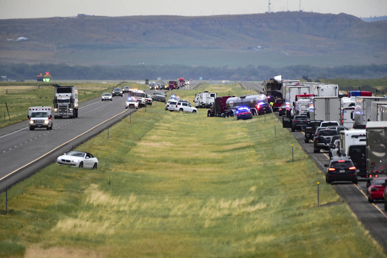 First responders work the scene on Interstate 90 after a fatal pileup where at least 20 vehicles crashed near Hardin, Mont., on July 15, 2022.