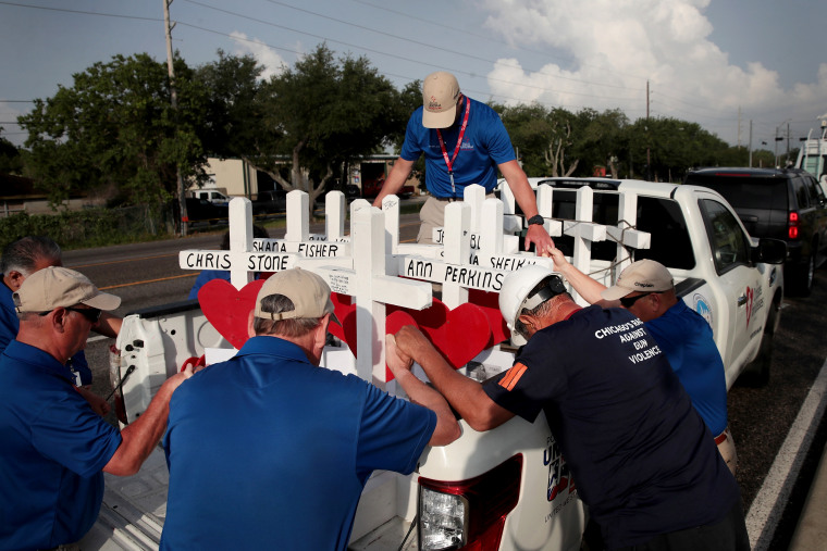 Image: Volunteers pray with crosses to memorialize the victims of a mass shooting at Santa Fe High School in Texas on May 21, 2018.