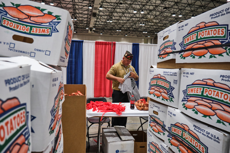 Michael Braman checks out a t-shirt he was given for his efforts in helping to bag up sweet potatoes at the VFW's Big 10 Conference Caucus in Kansas City, Mo., on July 16, 2022.