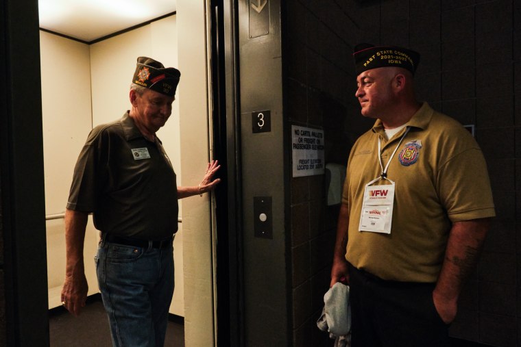 Michael Braman waits for a fellow veteran to exit the elevator at the VFW National Convention in Kansas City, Mo., on July 16, 2022.