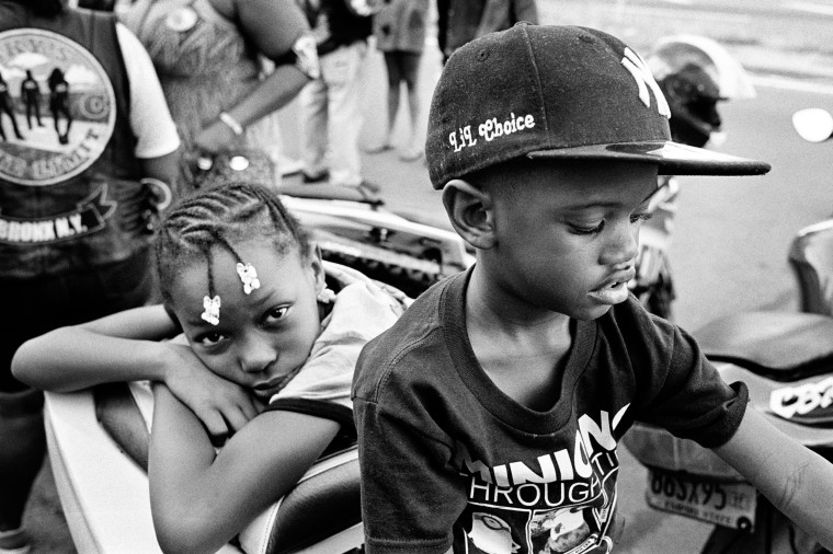 The children of biker Prez Choice outside the Black Falcons motorcycle club in the Bronx.