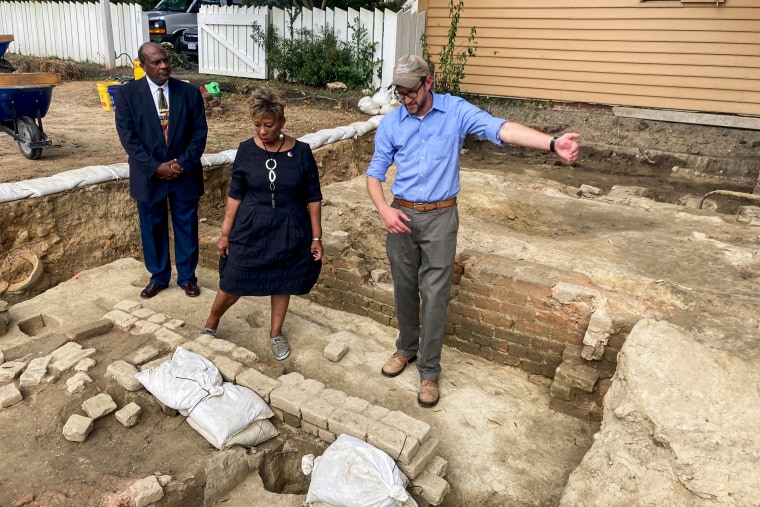 First Baptist Church pastor Reginald F. Davis, left, parishioner Connie Matthews Harshaw, and Jack Gary, Colonial Williamsburg's director of archaeology, stand at the brick-and-mortar foundation of one the oldest Black churches in the U.S. on Oct. 6, 2021, in Williamsburg, Va.