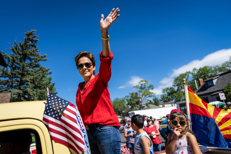 Kari Lake, Republican candidate for Governor of Arizona, waves at the Flagstaff Chamber of Commerce Fourth of July Parade in Flagstaff, Ariz., on July 4, 2022.
