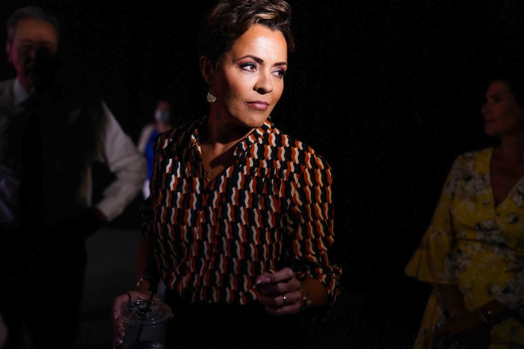 Kari Lake talks with her staff prior to a Arizona PBS televised debate, on June 29, 2022, in Phoenix.