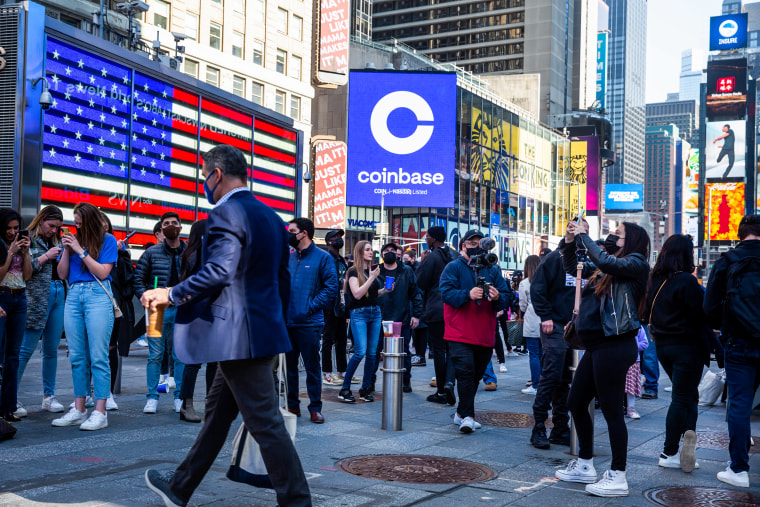 Monitors display Coinbase signage during the company's initial public offering at the Nasdaq MarketSite in New York on April 14, 2021.