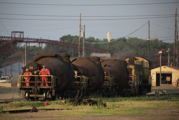 Image: Steelworkers ride on a bottle train transporting molten steel on the grounds of the U.S. Steel Corp. Granite City Works steel mill in Granite City, Ill., on July 7, 2021.