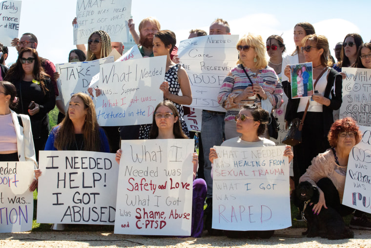 Demonstrators protest institutional child abuse at the Capitol on May 11, 2022.