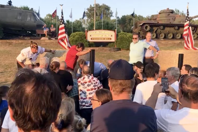 NY GOP Candidate for Governor Rep. Lee Zeldin, R-NY, top right, is protected by an unidentified man wearing sunglasses as others apprehend a man who attacked Rep. Zeldin at the campaign event in Fairport, N.Y., on July 21, 2022.