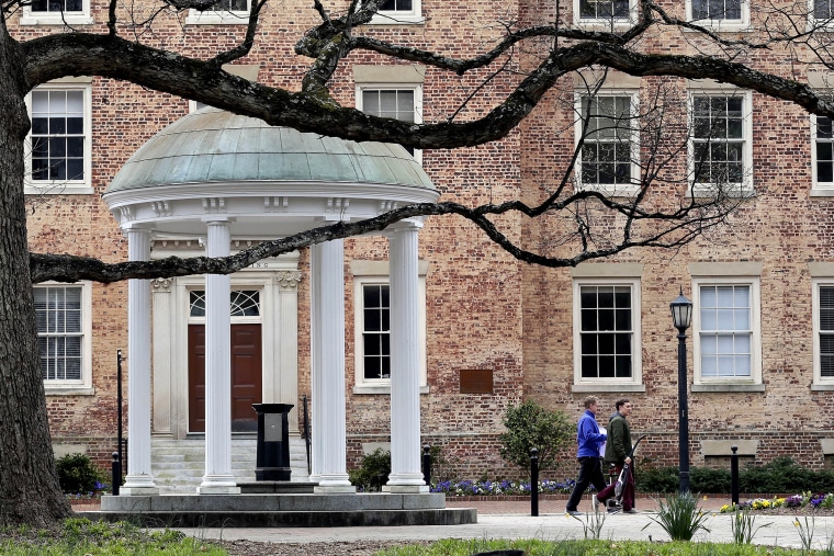 People remove belongings on campus at the University of North Carolina in Chapel Hill, N.C., on March 18, 2020.