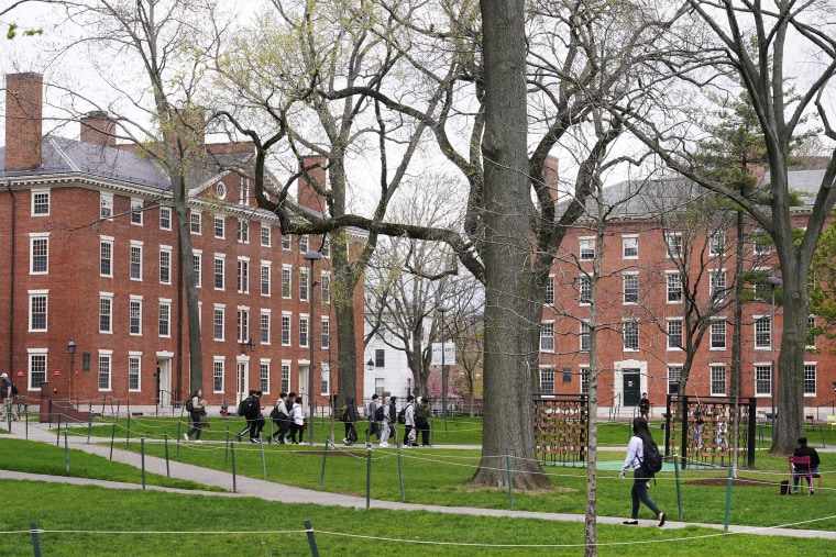 Students walk through Harvard Yard on the Harvard University campus on April 27, 2022 in Cambridge, Massachusetts.