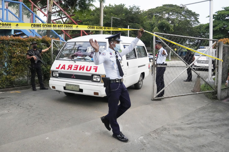 An emergency vehicle exits the Ateneo de Manila University
