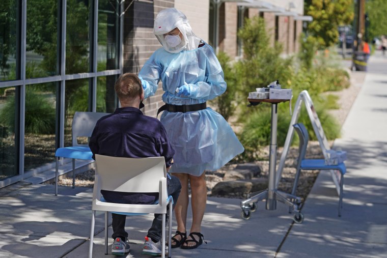 Image: A person receives a Covid-19 test outside the Salt Lake County Health Department on July 22, 2022.