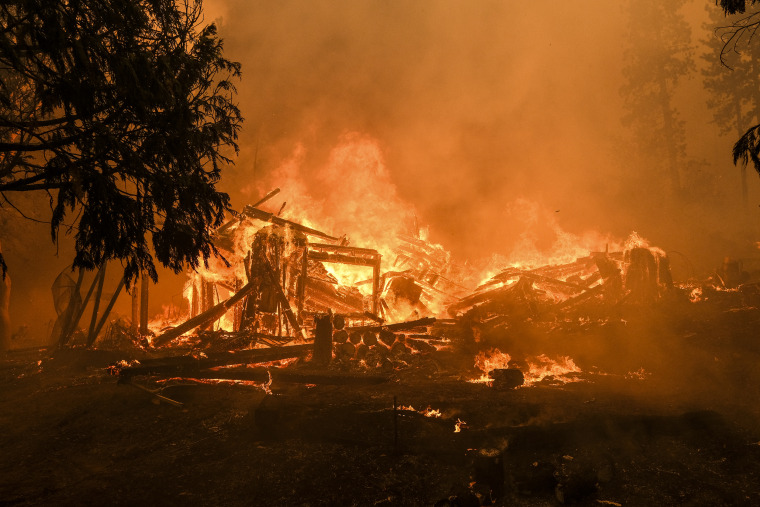 Image: A structure burns during the Oak Fire in Mariposa County, Calif. on July 23, 2022.