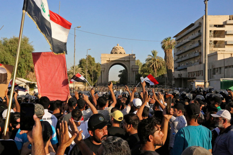 Protesters gather utside the main gate of Baghdad