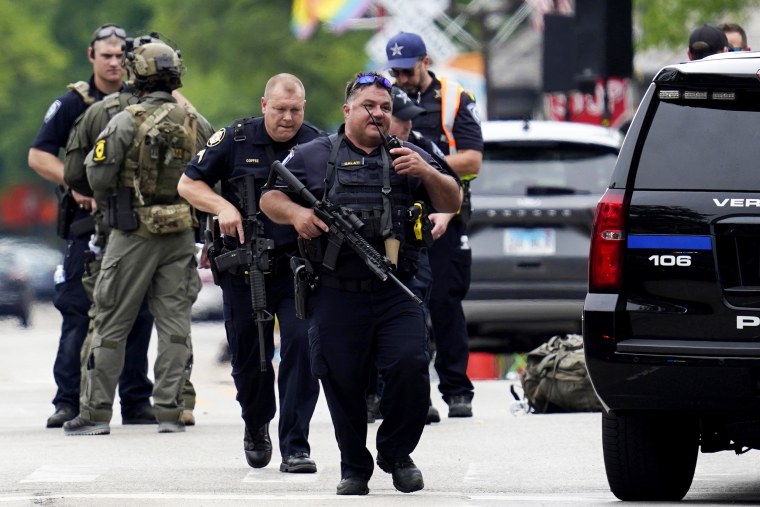 Law enforcement search after a mass shooting in Highland Park, Ill.