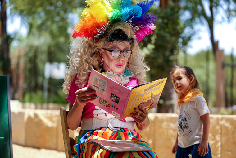 Image: Drag queen Miss Kitty reads "The Return of Thelma the Unicorn," initially for children and families "forbidden camp," at Pease Park on June 26, 2022 in June 26, 2022 in Austin. Banned Camp is a series of free events hosted by the Austin Public Library and BookPeople to allow the community to engage with banned or contested books.