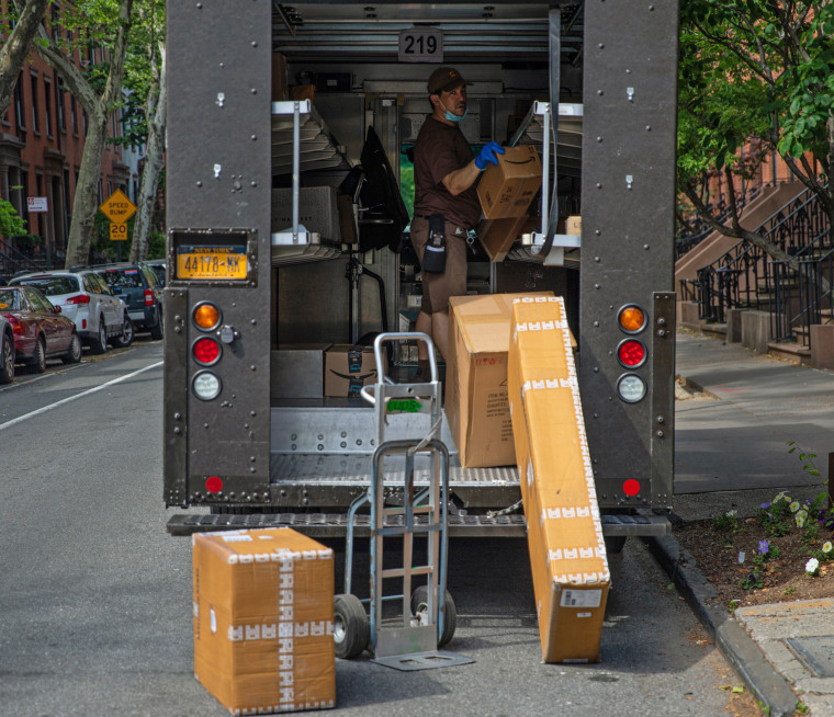 Boxes are unloaded by a United Parcel Service delivery person on May 29, 2020 in Brooklyn, N.Y.