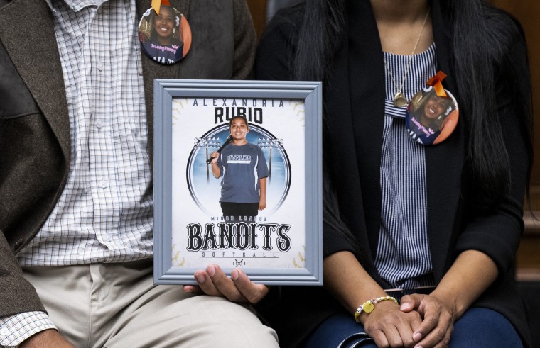Image: Parents of 10 year old Alexandria Rubio, who was killed during the shooting at Robb Elementary School in Uvalde, Texas, in May 2022, hold a photo of their daughter during a House Committee on Oversight and Reform hearing on Examining the Practices and Profits of Gun Manufacturers in Washington, D.C., on July 27, 2022.